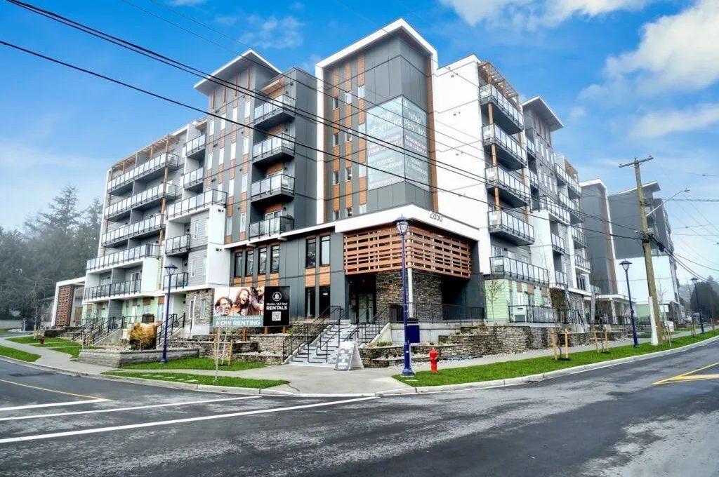 Completed mixed-use building with concrete flatwork at grade